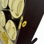 Ebony high-gloss 12 watch winder close-up showing gold-tone hardware lock and beige winding modules