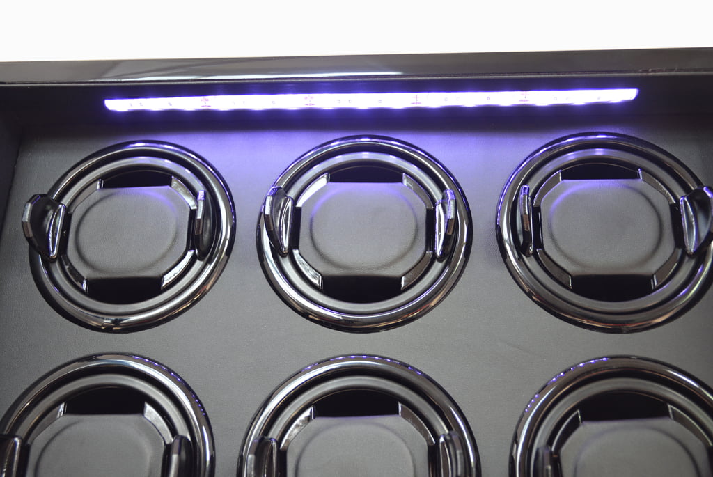 Six watch winder interior with LED light illuminating the watch holders