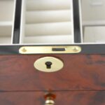 Jewelry box interior with ring rolls and earring storage panel