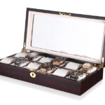 Open 12 watch display case with beige velvet interior, padded watch holders and tempered glass lid