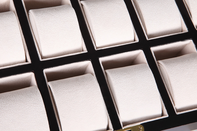 12 watch case interior with beige velvet-wrapped compartments and individual padded holders