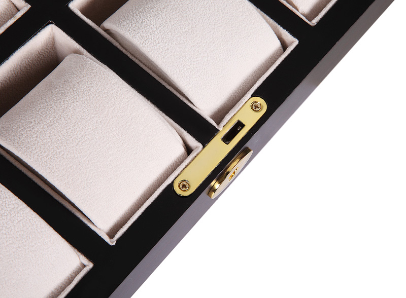Watch case interior with beige padded holders and gold-tone hardware lock detail