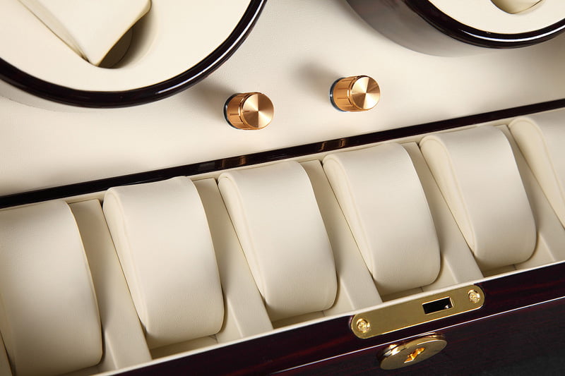 Watch winder interior with six beige watch storage positions and two control knobs