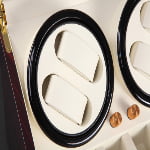 Watch winder winding module with beige watch holders and gold-tone control knobs