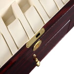 Ebony watch winder with beige storage positions and gold-tone hardware lock