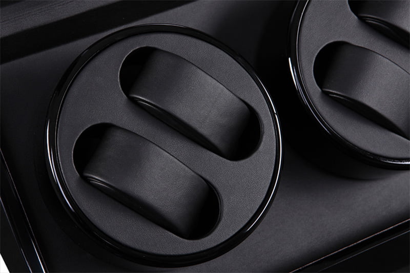 4-watch winder close-up showing black dual watch cushions and PU leather-wrapped interior