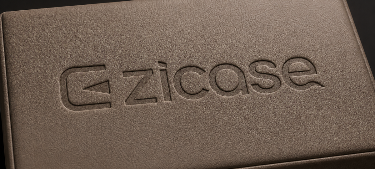 Debossed or embossed logo detail on a wrapped box surface
