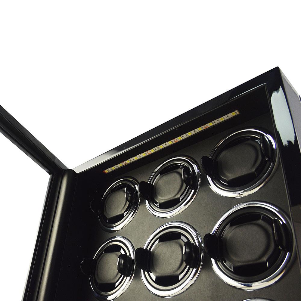 9 watch winder interior with LED light above black watch cushions and winding positions