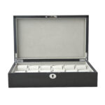 Carbon fiber watch box open with velvet interior and watch compartments