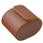 brown single watch travel box with watch and snap button closure