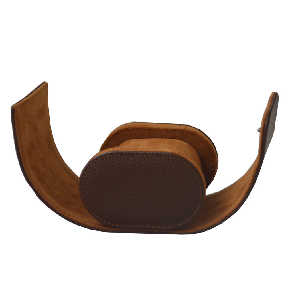 Open brown single watch travel box with velvet-lined interior and watch cushion