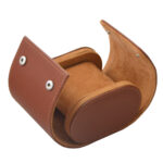 Open brown watch travel box with velvet-lined interior and watch cushion