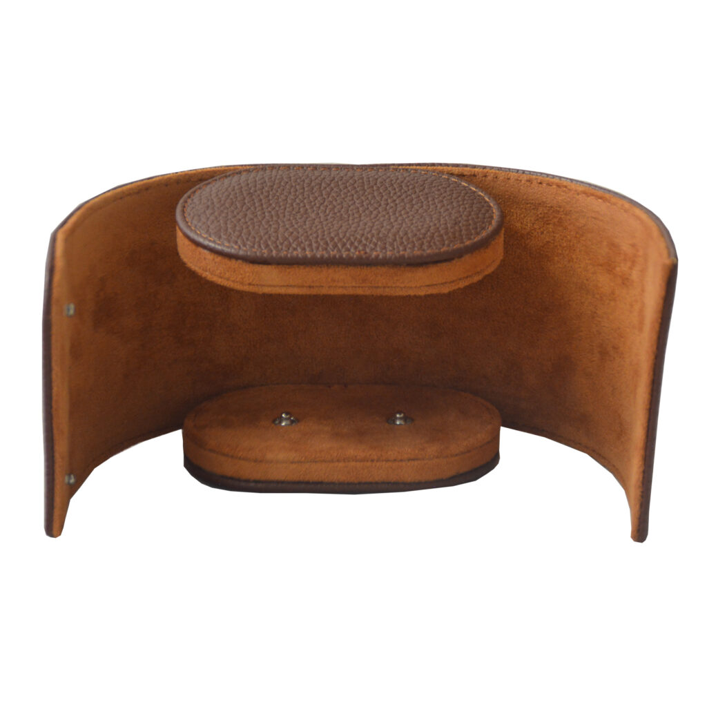 Brown watch travel box opened flat to show velvet-lined interior and cushion