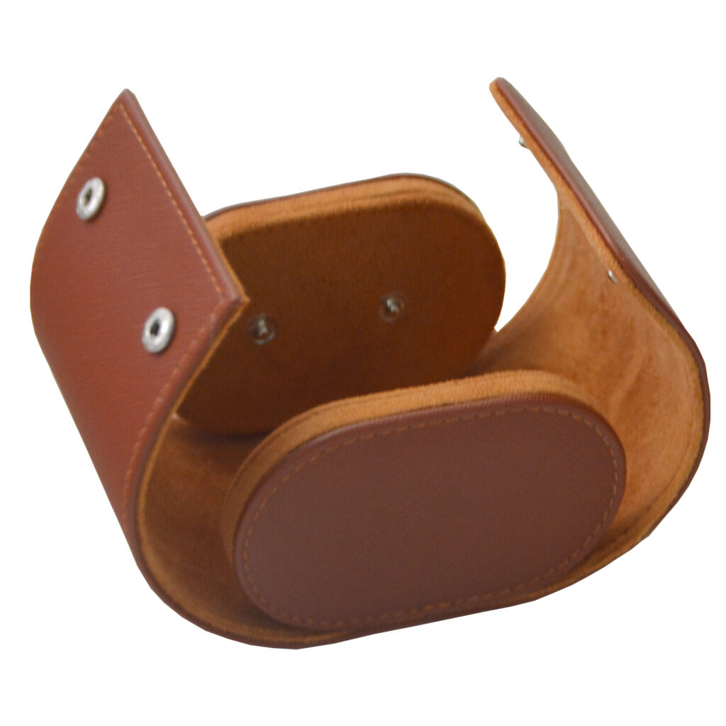 Open single watch travel box showing brown velvet-lined interior and cushion