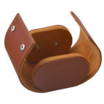 Open single watch travel box showing brown velvet-lined interior and cushion