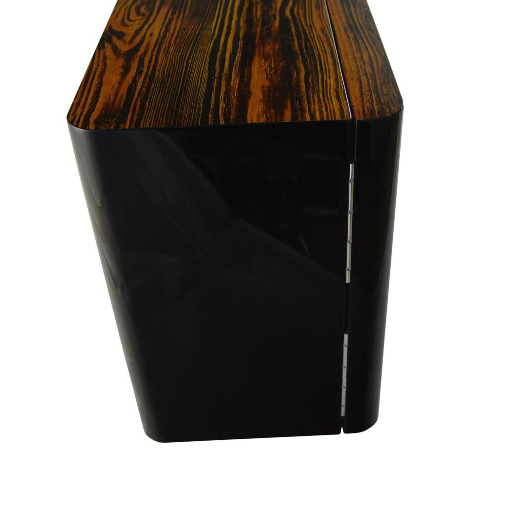 Watch winder side view showing high-gloss black cabinet, zebra stripe top and metal hinges