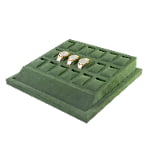 Green velvet watch tray with three watches displayed