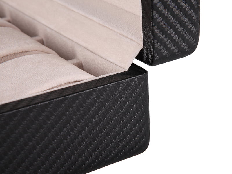 Carbon fiber watch case corner detail with beige velvet interior