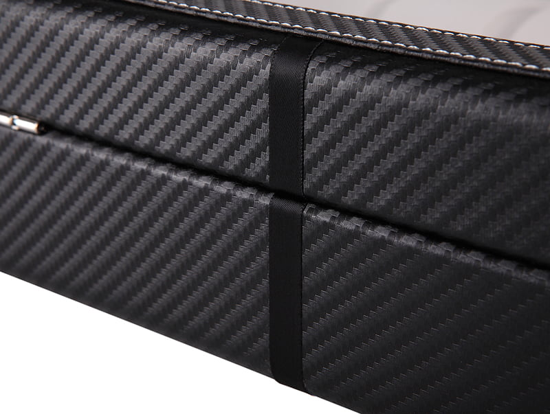 Black carbon fiber watch case exterior showing rear finish and trim detail