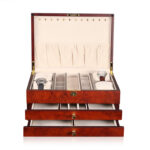 Wooden jewelry organizer box open with multiple drawers and compartments