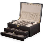 Black jewelry storage box with open drawers and velvet interior