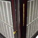 Ebony watch strap display cabinet close-up with gold-tone hinge and beige divided interior