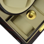 Ebony 2-watch winder interior detail showing gold-tone knob control and beige watch storage position