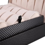 Carbon fiber watch case interior with beige watch cushions and pull tab