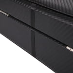 Carbon fiber watch box showing metal hinge detail and structured lid design
