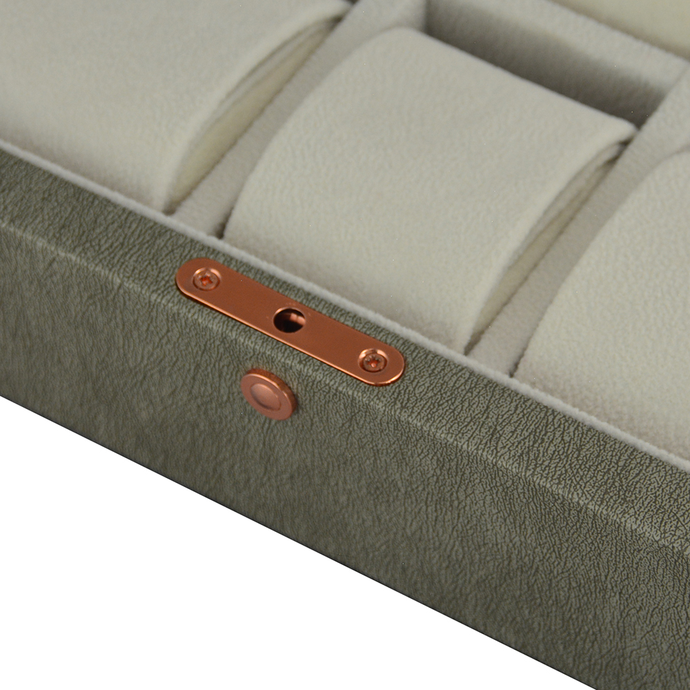Grey watch box displaying wrist watches with individual cushions
